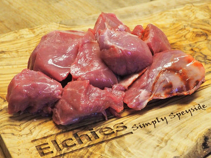 A portion of diced goat leg meat displayed on a branded Elchies wooden board. 