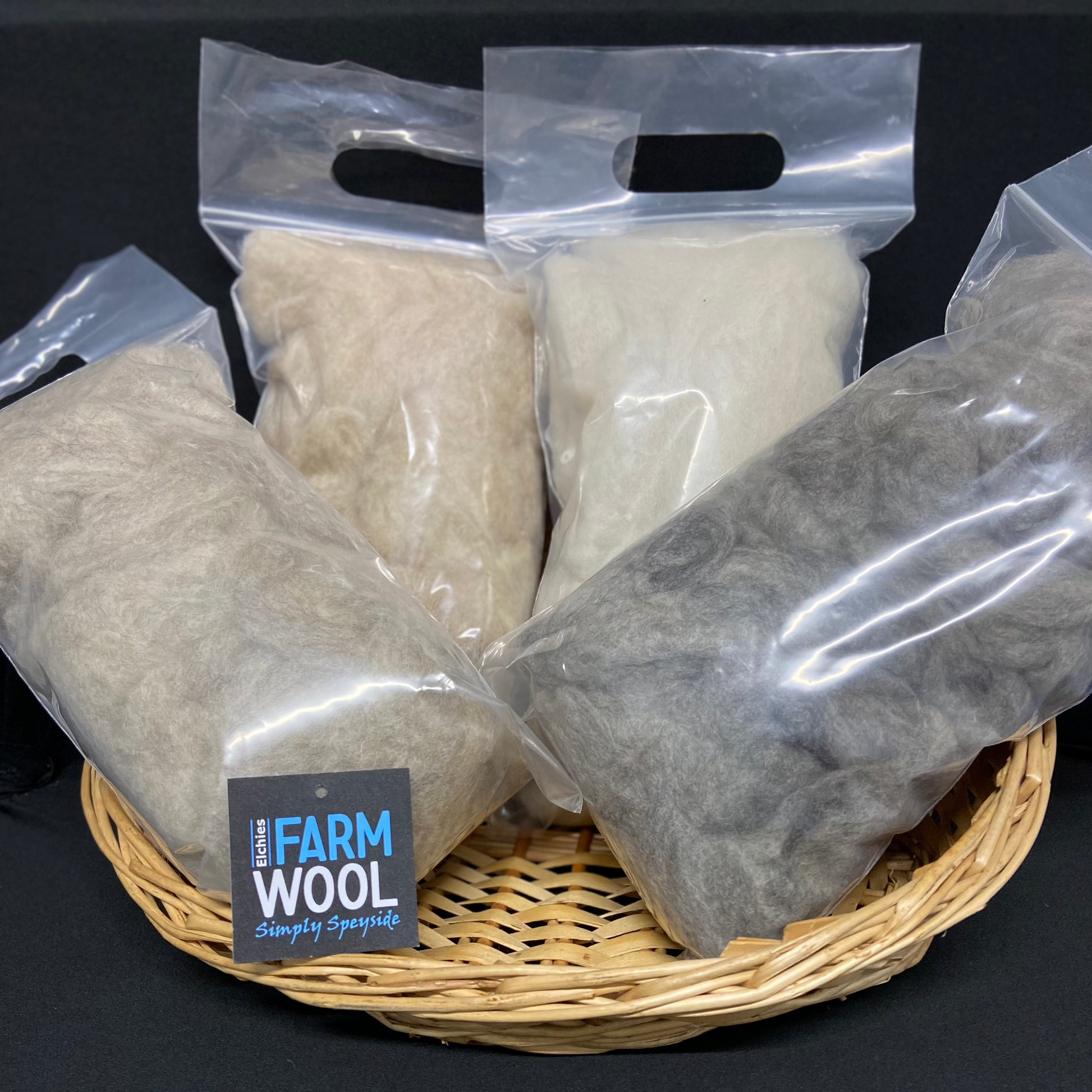 Four packets of Elchies Farm felted wool in a woven display basket.