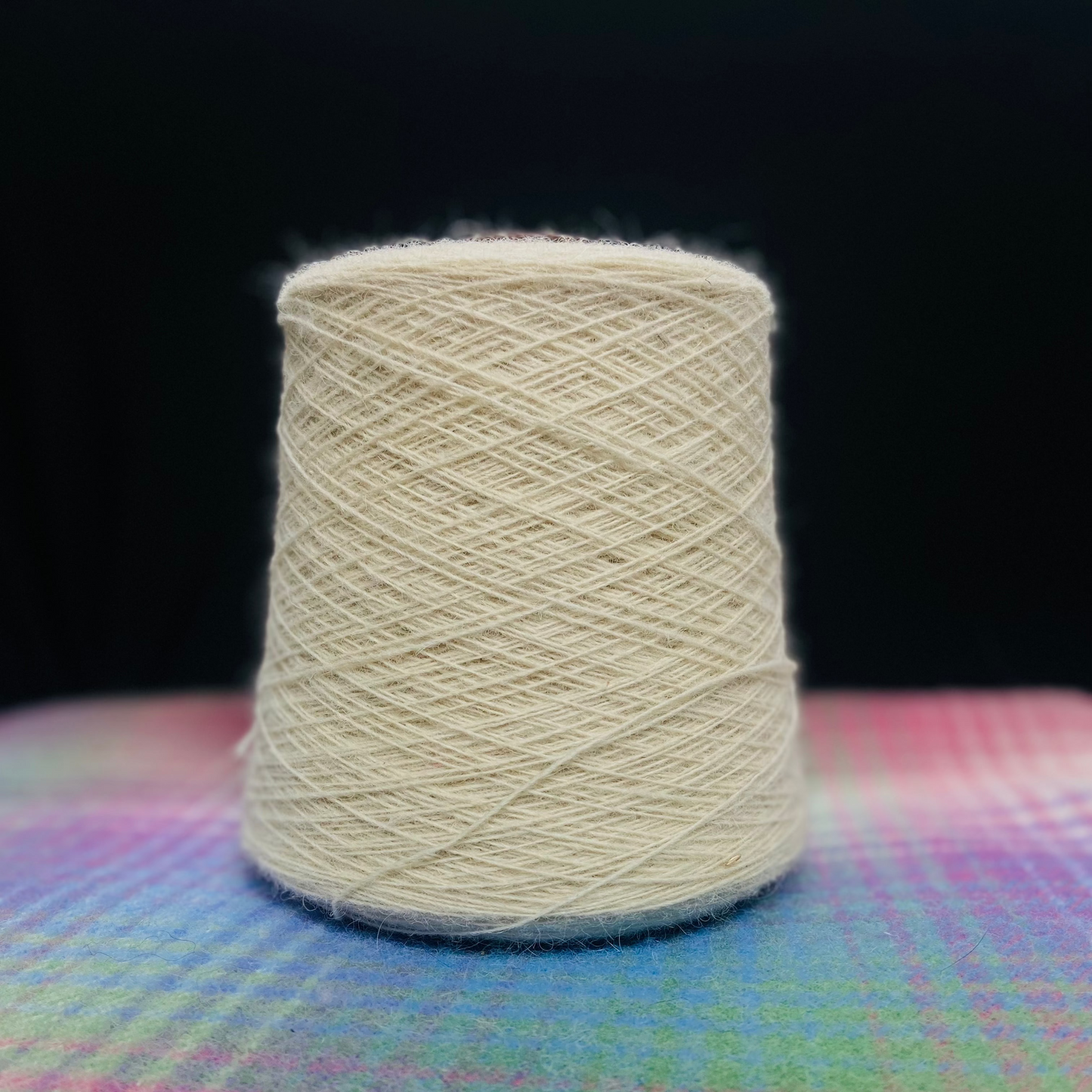 A cone of Elchies Farm Wool in the shade 'Natural'.