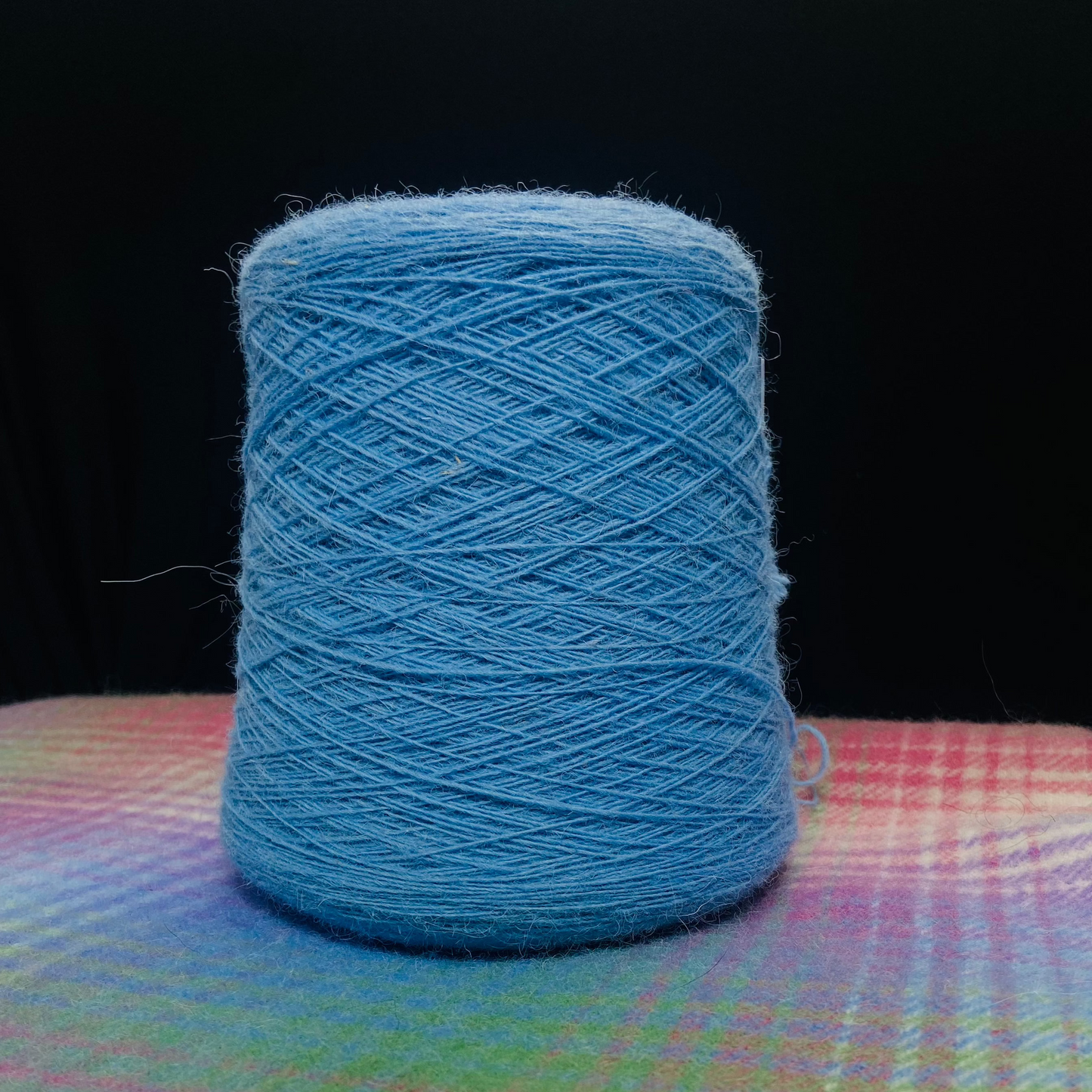 A cone of Elchies Farm Wool in the shade 'Sky Blue'.