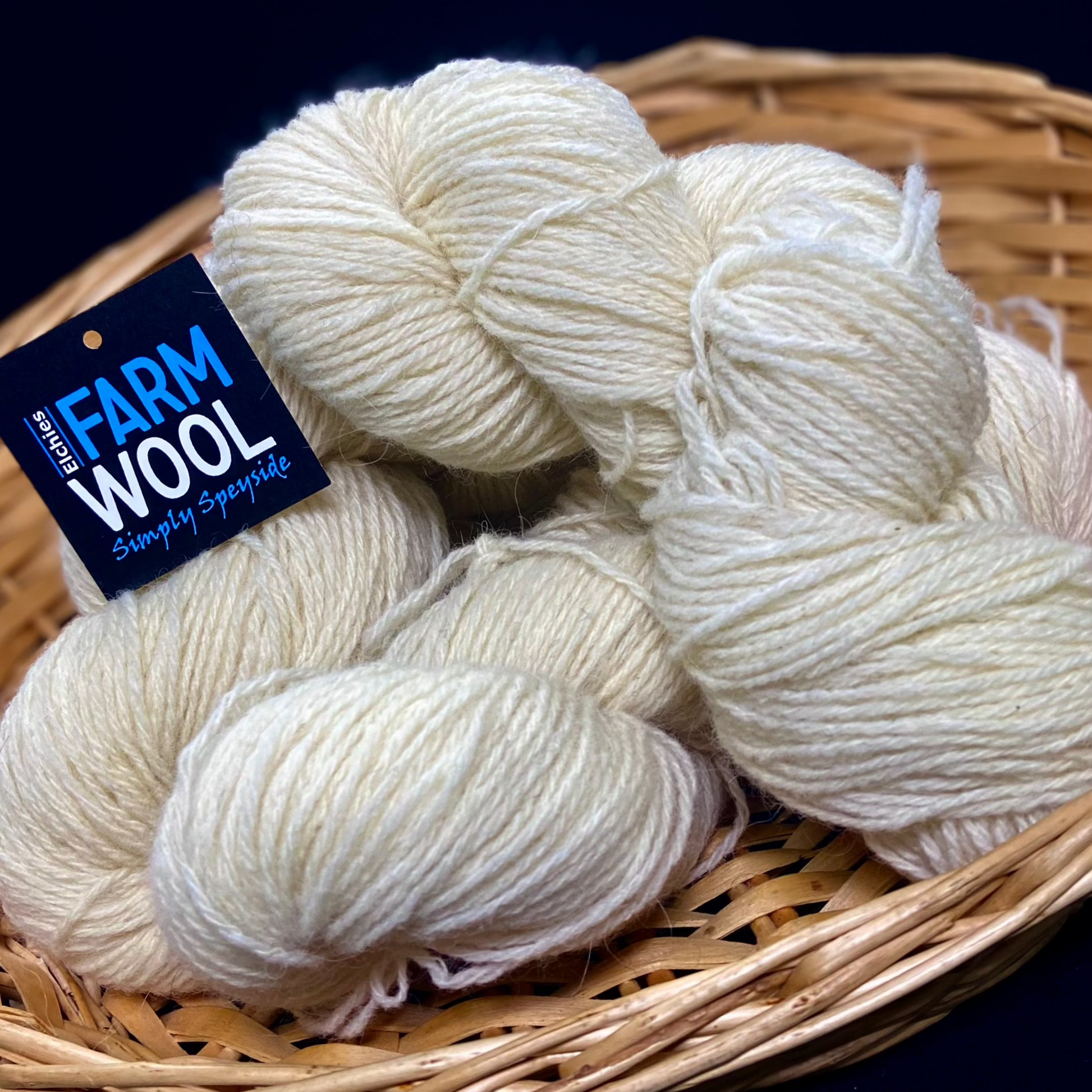 A basket of Elchies Farm Wool Hanks in the shade 'Natural'.