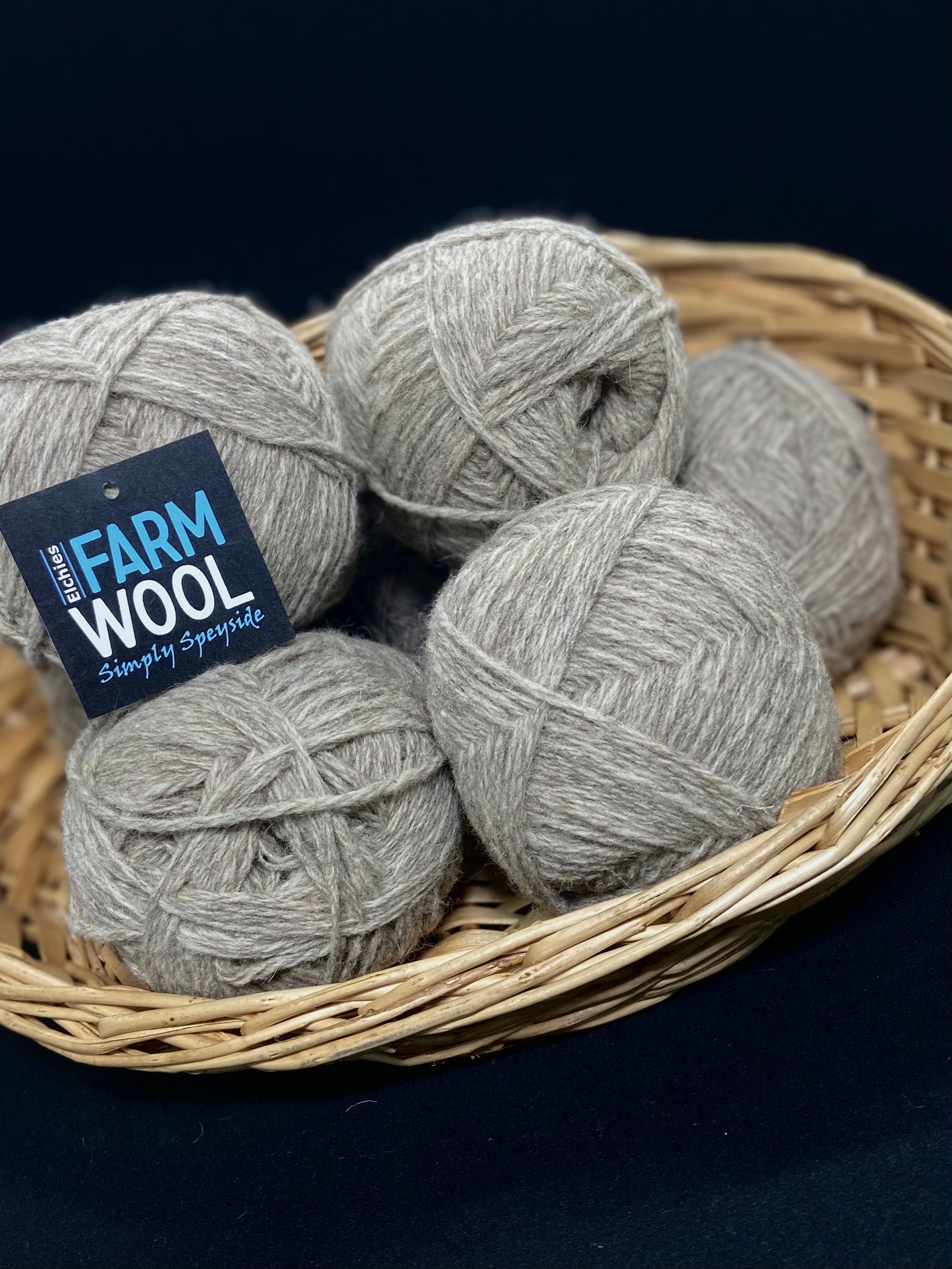 A basket of Elchies Farm Wool Balls in the shade 'Light Grey'.